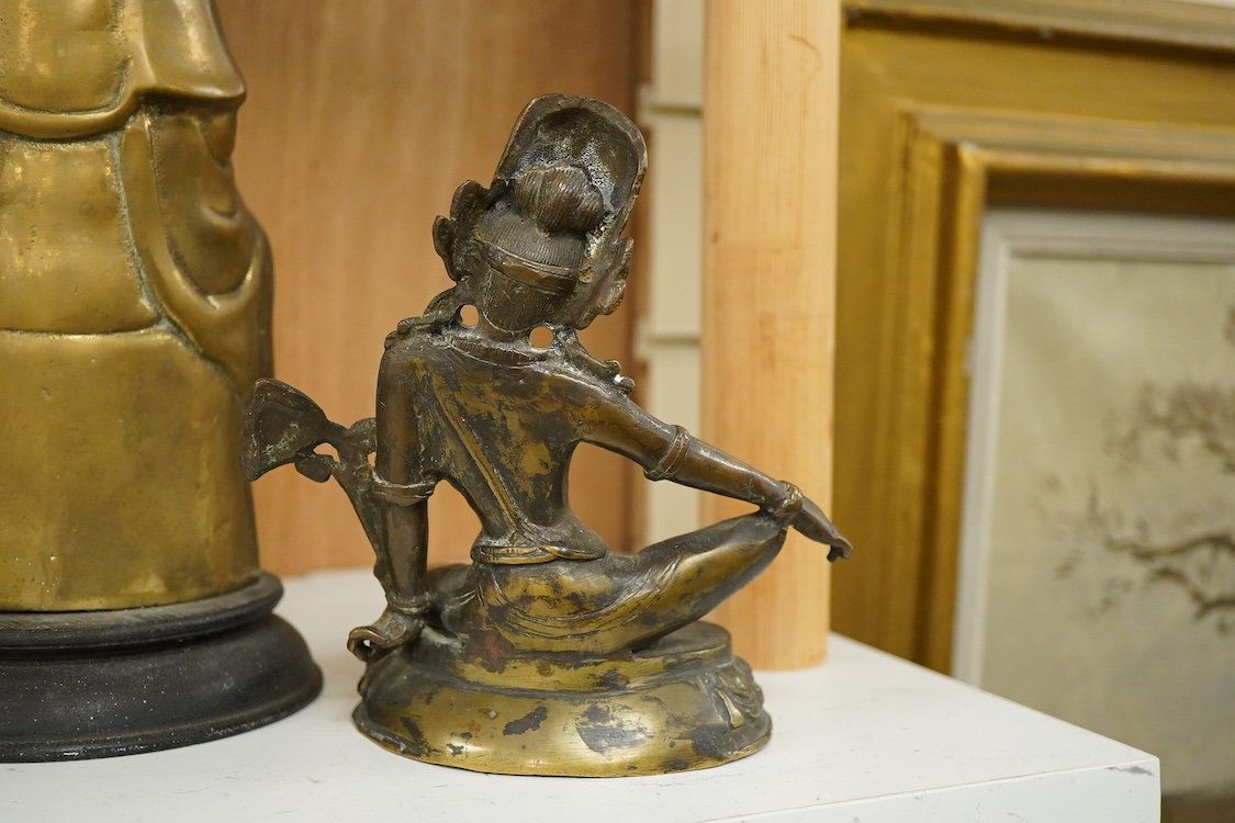 Three South East Asian brass figures to include one of Bodhisattva, largest 28cm high
